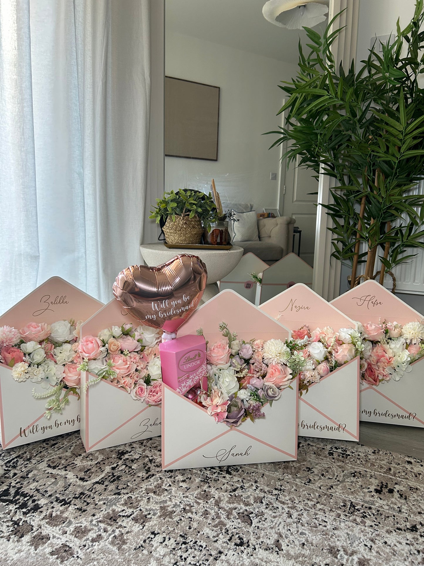 Pink and white envelope with flowers chocolate and balloon