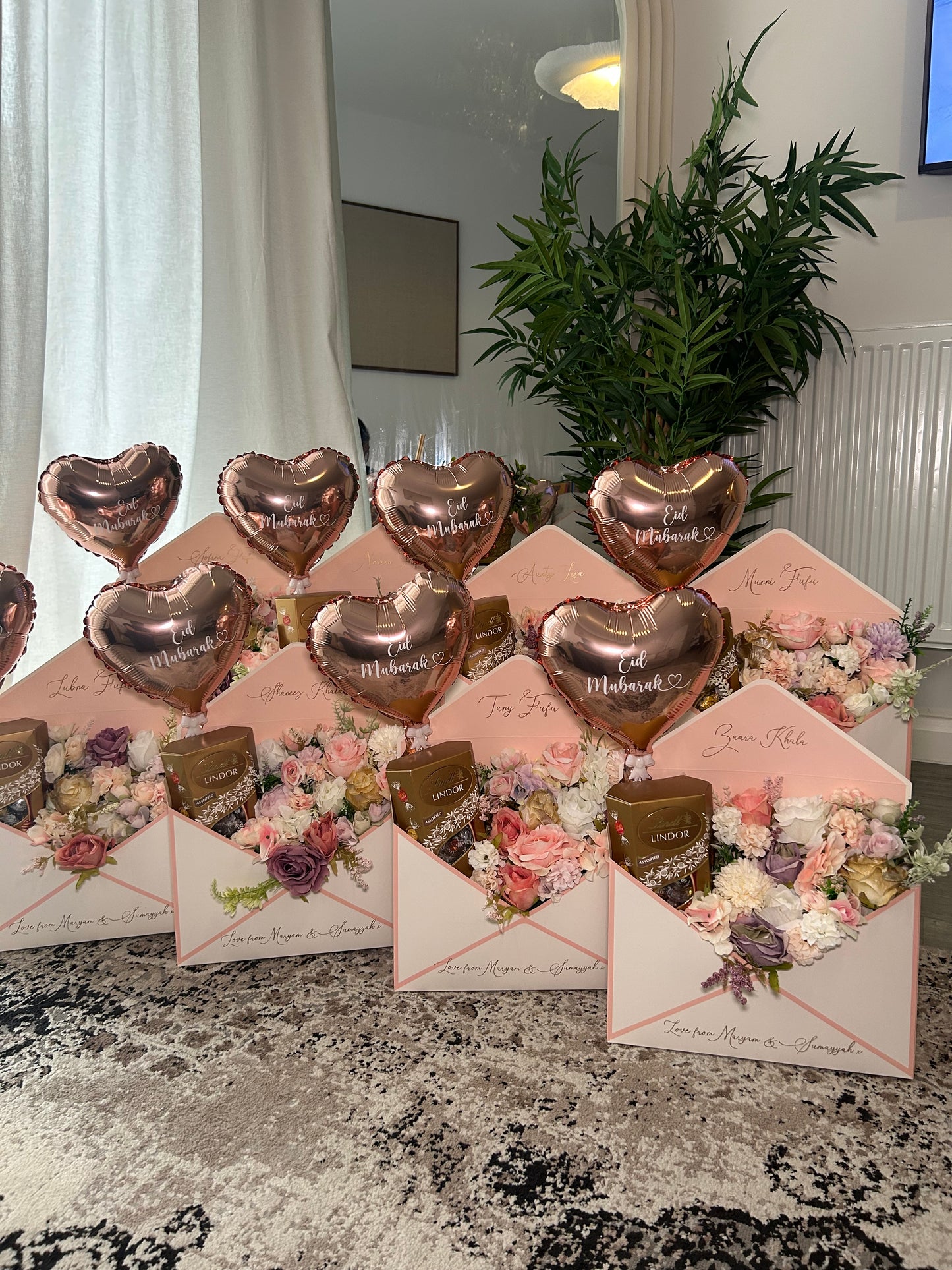 Pink and white envelope with flowers chocolate and balloon