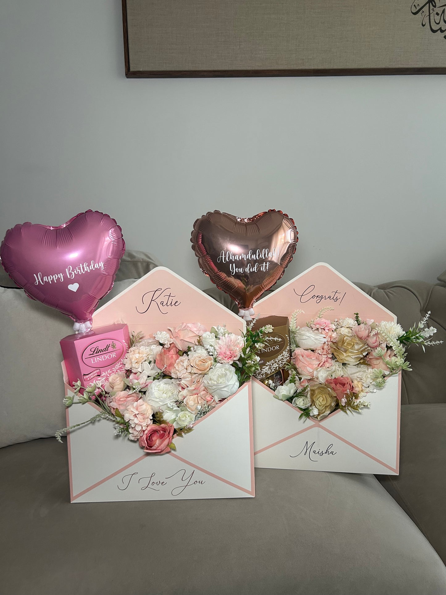 Pink and white envelope with flowers chocolate and balloon