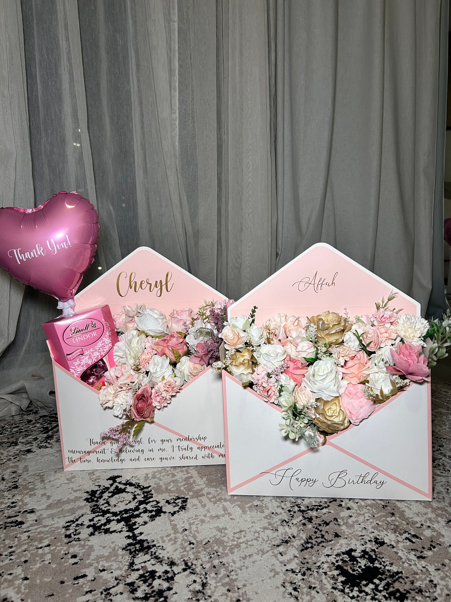 Pink and white envelope with flowers chocolate and balloon